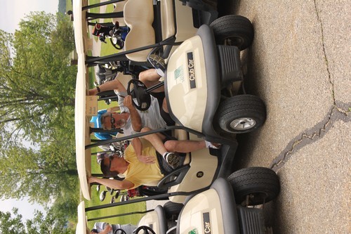 golfers in their carts awaiting the start of the outing